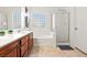 Modern bathroom showcasing a shower stall, a soaking tub, and wood cabinetry at 4916 White Jade St, North Las Vegas, NV 89081