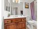 Bathroom featuring wood cabinets, a bathtub with shower, and framed mirrors at 4916 White Jade St, North Las Vegas, NV 89081