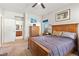This bright bedroom offers a wooden bed frame and dresser with carpeted floors at 4916 White Jade St, North Las Vegas, NV 89081