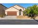 Inviting single-story home featuring a two-car garage, desert landscaping and an arched entry at 4916 White Jade St, North Las Vegas, NV 89081