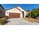 Inviting single-story home featuring a two-car garage, desert landscaping and an arched entry at 4916 White Jade St, North Las Vegas, NV 89081