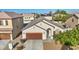 Inviting home exterior with a two-car garage, well-maintained landscaping, and desert style front yard at 4916 White Jade St, North Las Vegas, NV 89081
