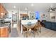 Open kitchen and dining area with wood cabinets and stainless steel appliances at 4916 White Jade St, North Las Vegas, NV 89081