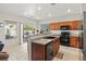 Bright kitchen with lots of light, stainless steel appliances, granite countertops, and dark wood cabinets at 4916 White Jade St, North Las Vegas, NV 89081