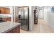 Modern kitchen features stainless steel appliances, wood cabinets, and tile floors at 4916 White Jade St, North Las Vegas, NV 89081