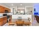 Open kitchen and dining area with wood cabinets and stainless steel appliances at 4916 White Jade St, North Las Vegas, NV 89081