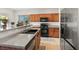 Well-lit kitchen with stainless steel appliances and wooden cabinets and granite countertops at 4916 White Jade St, North Las Vegas, NV 89081