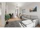 Bright living room with neutral walls, plush gray furniture, and a decorative geometric rug at 4916 White Jade St, North Las Vegas, NV 89081