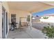 Covered patio with a swing bench, barbecue, and a view of the backyard at 4916 White Jade St, North Las Vegas, NV 89081