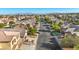 Street view showcasing the neighborhood's layout, with a tree lined street and residential properties at 4916 White Jade St, North Las Vegas, NV 89081