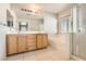 Bright bathroom with double vanity, large soaking tub, and separate shower at 5021 Ropers Rock Ct, Las Vegas, NV 89131