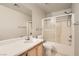 Standard bathroom featuring a shower-tub combination, toilet, vanity, and mirrored wall at 5021 Ropers Rock Ct, Las Vegas, NV 89131