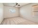 Well-lit bedroom with a ceiling fan and two windows offering bright, natural light at 5021 Ropers Rock Ct, Las Vegas, NV 89131