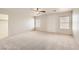 Spacious bedroom with neutral carpet, a ceiling fan, and window with blinds at 5021 Ropers Rock Ct, Las Vegas, NV 89131