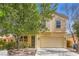 Charming two-story home with a well-maintained lawn and a two-car garage in a residential neighborhood at 5021 Ropers Rock Ct, Las Vegas, NV 89131