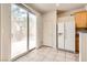 Bright kitchen area with sliding door access to the backyard and stainless refrigerator at 5021 Ropers Rock Ct, Las Vegas, NV 89131