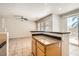 Bright kitchen featuring tile floors, granite counters, an island, and backyard access at 5021 Ropers Rock Ct, Las Vegas, NV 89131