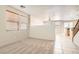 Spacious living room with tile flooring, plush carpeting, and ample natural light through large windows at 5021 Ropers Rock Ct, Las Vegas, NV 89131