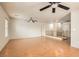 Spacious living area with hardwood floors, ceiling fans, staircase and neutral walls at 5021 Ropers Rock Ct, Las Vegas, NV 89131