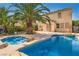 Backyard with a sparkling blue pool, mature landscaping and a spacious patio for outdoor entertaining at 5021 Ropers Rock Ct, Las Vegas, NV 89131