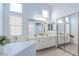 Spacious bathroom with dual sinks, vanity, and a glass enclosed shower, offering a spa-like experience at 5108 Molveno Ct, Las Vegas, NV 89130
