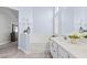 Elegant bathroom featuring a tub, double sink vanity, shutters and modern tile floor at 5108 Molveno Ct, Las Vegas, NV 89130