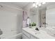 Bright bathroom featuring a tub and shower combo with a white tiled wall and modern vanity at 5108 Molveno Ct, Las Vegas, NV 89130