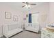 Charming Bedroom with two white cribs, soft pink walls, and natural light creating a peaceful environment at 5108 Molveno Ct, Las Vegas, NV 89130