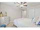 Bright bedroom featuring a ceiling fan, dresser with decor, and comfortable carpet flooring at 5108 Molveno Ct, Las Vegas, NV 89130