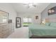 Well-lit bedroom featuring a bed, dresser, and a sliding door to the backyard at 5108 Molveno Ct, Las Vegas, NV 89130