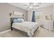 Comfortable bedroom with a floral-patterned bed, ceiling fan, and a dresser near the window at 5108 Molveno Ct, Las Vegas, NV 89130