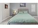 Cozy bedroom featuring a gray bed frame, matching nightstand and art on the wall at 5108 Molveno Ct, Las Vegas, NV 89130