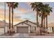 Charming single-Gathering home with desert landscaping, mature palm trees, and a two-car garage at 5108 Molveno Ct, Las Vegas, NV 89130