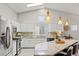 Bright kitchen with white cabinets, stainless steel appliances, and a large island, great for entertaining at 5108 Molveno Ct, Las Vegas, NV 89130