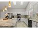 Modern kitchen featuring white cabinets, a stainless steel appliance, and a large island with granite countertops at 5108 Molveno Ct, Las Vegas, NV 89130