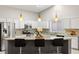 Bright kitchen features granite countertops, stainless steel appliances, and stylish pendant lighting at 5108 Molveno Ct, Las Vegas, NV 89130