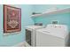 Bright laundry room featuring modern white appliances and a decorative rug at 5108 Molveno Ct, Las Vegas, NV 89130