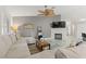 Comfortable living room with fireplace, ceiling fan, and cozy sectional sofa at 5108 Molveno Ct, Las Vegas, NV 89130