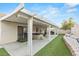 Large covered patio with a hot tub, outdoor seating, and a landscaped yard, perfect for entertainment at 5108 Molveno Ct, Las Vegas, NV 89130