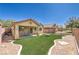 Cozy backyard with artificial turf, patio, and swing set, perfect for relaxing and entertaining at 5687 Harbour Pointe Ave, Las Vegas, NV 89122