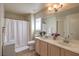Bright bathroom featuring double sinks, a shower, and ample counter space at 5687 Harbour Pointe Ave, Las Vegas, NV 89122