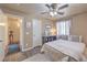 Well-lit bedroom includes a ceiling fan, closet, carpet flooring, and large windows at 5687 Harbour Pointe Ave, Las Vegas, NV 89122
