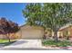 Charming single-story home featuring a well-manicured front yard with mature shade trees and a two-car garage at 5687 Harbour Pointe Ave, Las Vegas, NV 89122