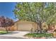 Charming single-story home featuring a well-manicured front yard with mature shade trees and a two-car garage at 5687 Harbour Pointe Ave, Las Vegas, NV 89122