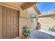 Inviting front porch with a potted plant and outdoor seating for enjoying the fresh air at 5687 Harbour Pointe Ave, Las Vegas, NV 89122