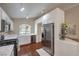 Bright kitchen featuring white cabinets, stainless appliances, wood floors, and granite countertops at 5687 Harbour Pointe Ave, Las Vegas, NV 89122