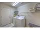 Functional laundry area with a washer, dryer, storage shelves, and plenty of space at 5687 Harbour Pointe Ave, Las Vegas, NV 89122