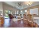 Bright living area with hardwood floors, neutral tones, and open floor plan to the dining area at 5687 Harbour Pointe Ave, Las Vegas, NV 89122