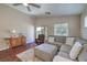 Comfortable living room with a sectional sofa, leather recliner and sliding doors to the backyard at 5687 Harbour Pointe Ave, Las Vegas, NV 89122