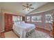 Spacious main bedroom boasts a ceiling fan, wardrobe, and large windows at 5687 Harbour Pointe Ave, Las Vegas, NV 89122